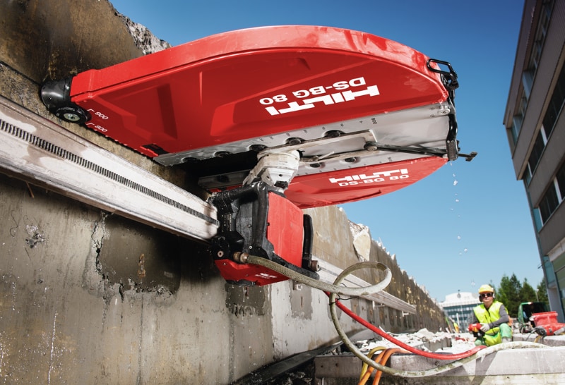 Worker cutting concrete wall with Hilti DST 20-CA